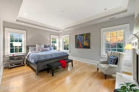 a bathroom with a double vanity sink mirror and bathtub