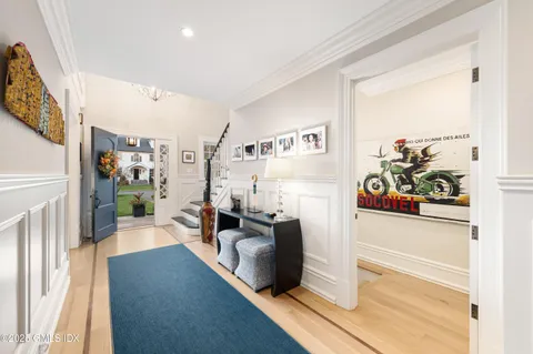 a view of entryway and hall with wooden floor
