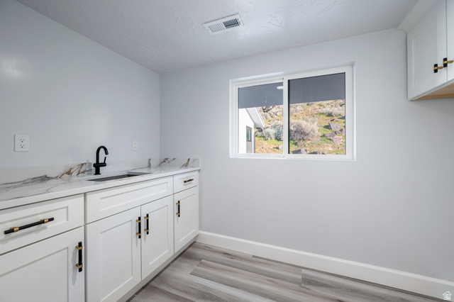 476 Spring Drive Toquerville, UT 84774 - Photo 76 of 95 Laundry room featuring light wood-type flooring and cabinet space