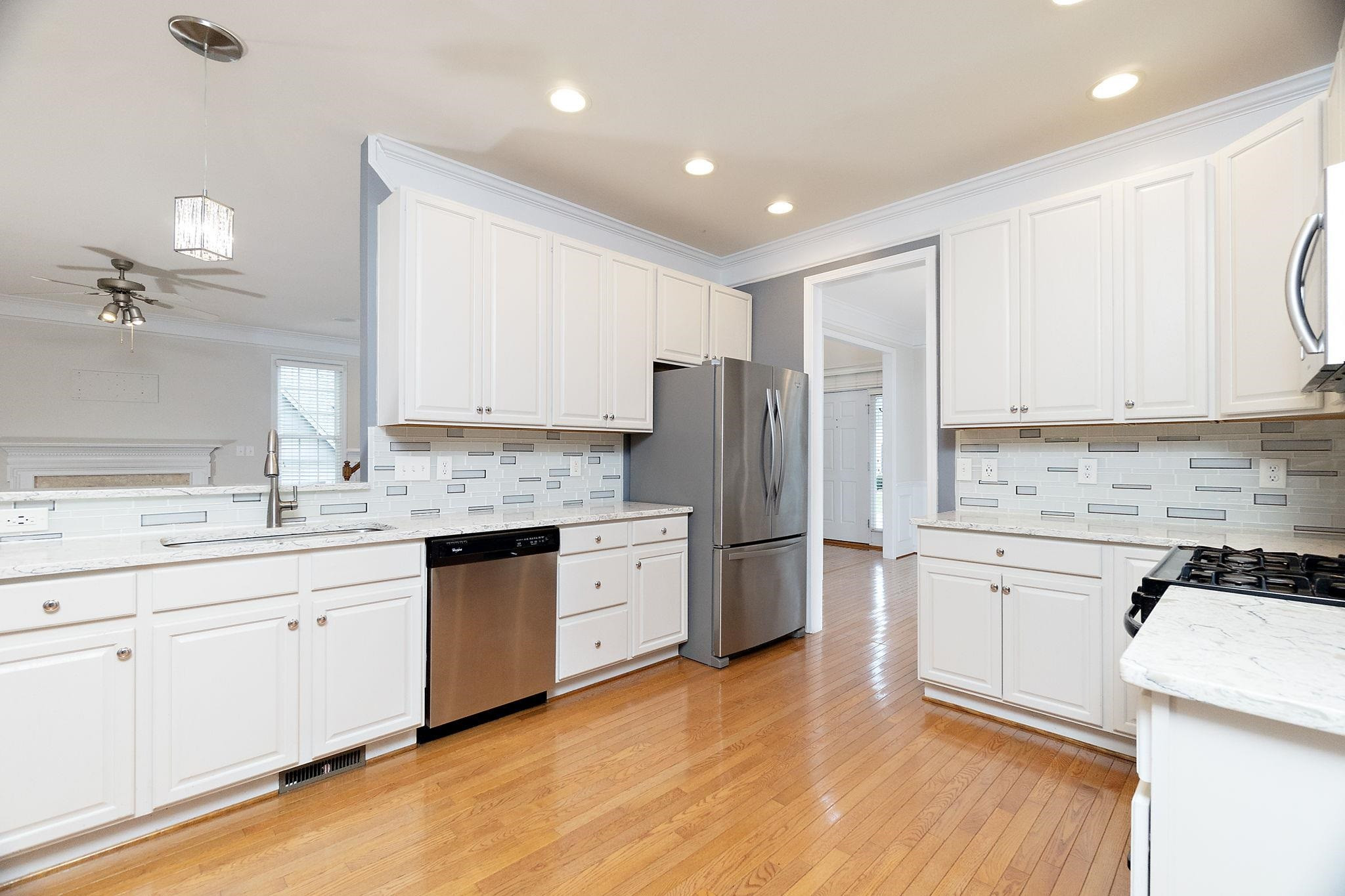 5916 Currin Fox Court Raleigh, NC 27616 - Photo 14 of 43 a kitchen with a refrigerator stove top oven and sink