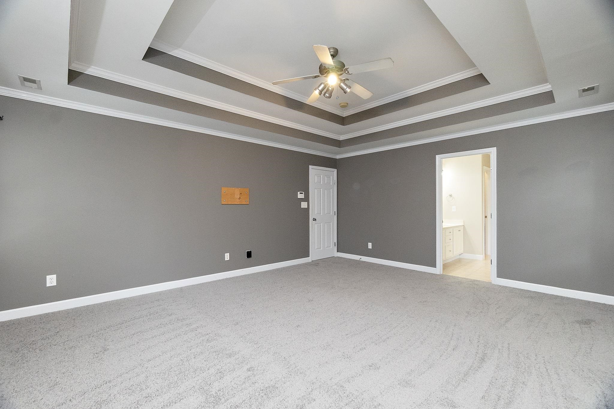 5916 Currin Fox Court Raleigh, NC 27616 - Photo 23 of 43 a view of an empty room with a chandelier fan