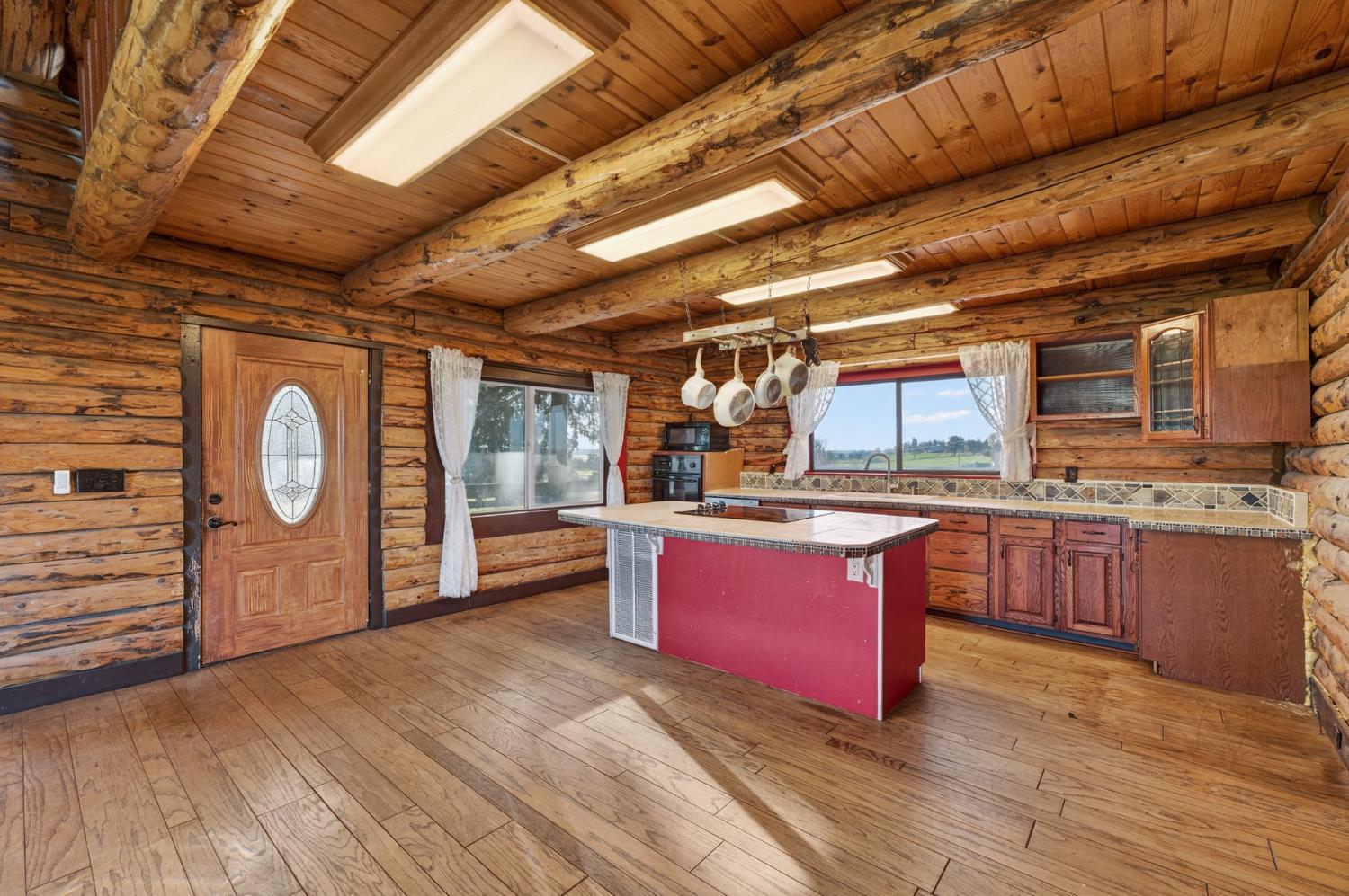 9798 Butte View Marysville, CA 95901 - Photo 11 of 55 a large room with kitchen island wooden floors wooden cabinets