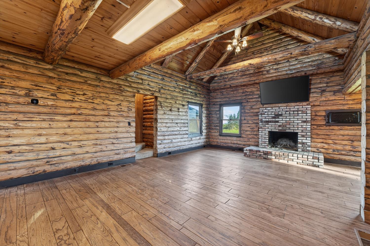 9798 Butte View Marysville, CA 95901 - Photo 16 of 55 a view of an empty room with wooden floor and a fireplace