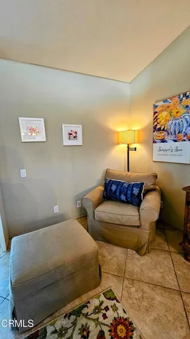 a bed room with two beds and paintings on the wall