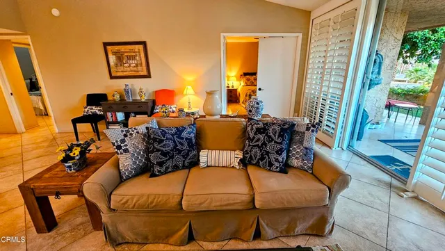 a outdoor living space with furniture and a flat screen tv