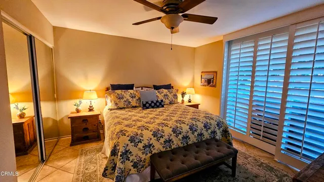 a bedroom with a bed and flat screen tv