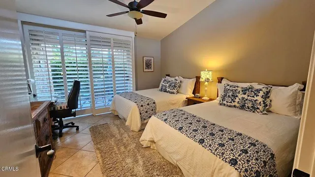 a bedroom with two beds and a chandelier