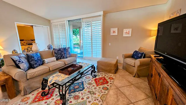 a bedroom with a bed and painting on the wall