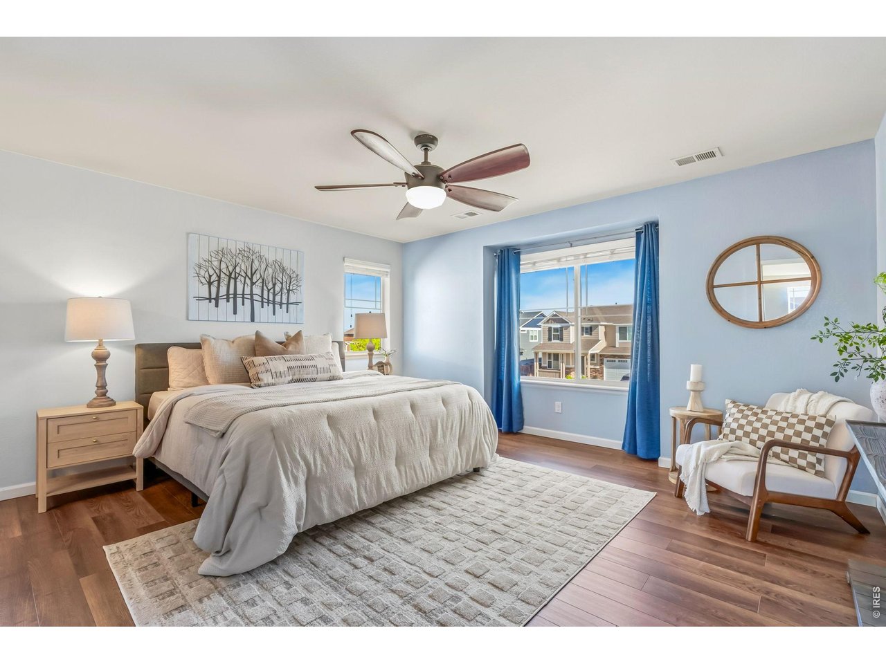 6759 Rainier Road Timnath, CO 80547 - Photo 12 of 30 a bedroom with a large bed and a chandelier