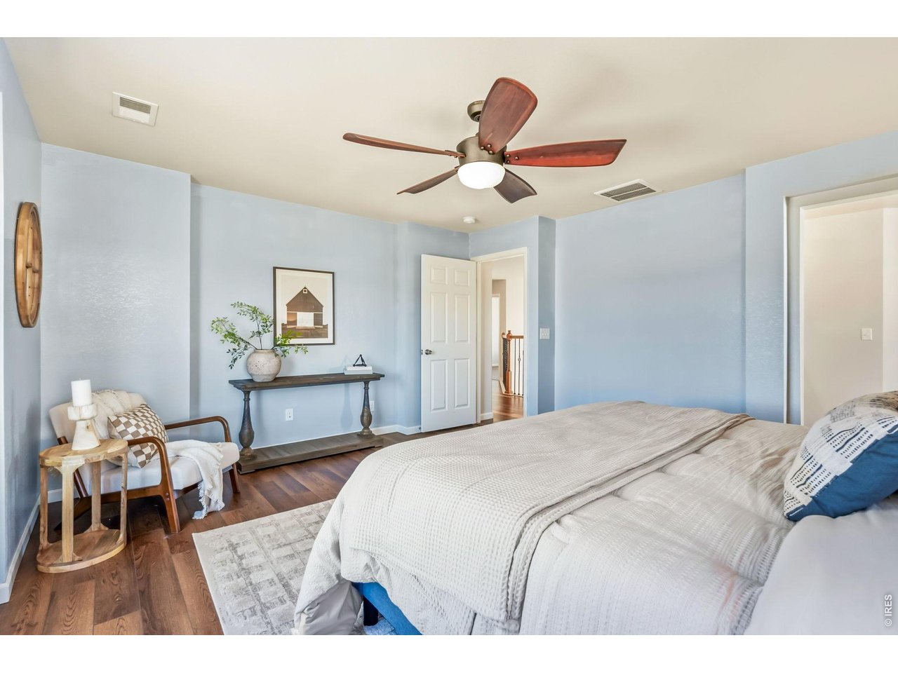 6759 Rainier Road Timnath, CO 80547 - Photo 13 of 30 a bedroom with a bed and a chandelier