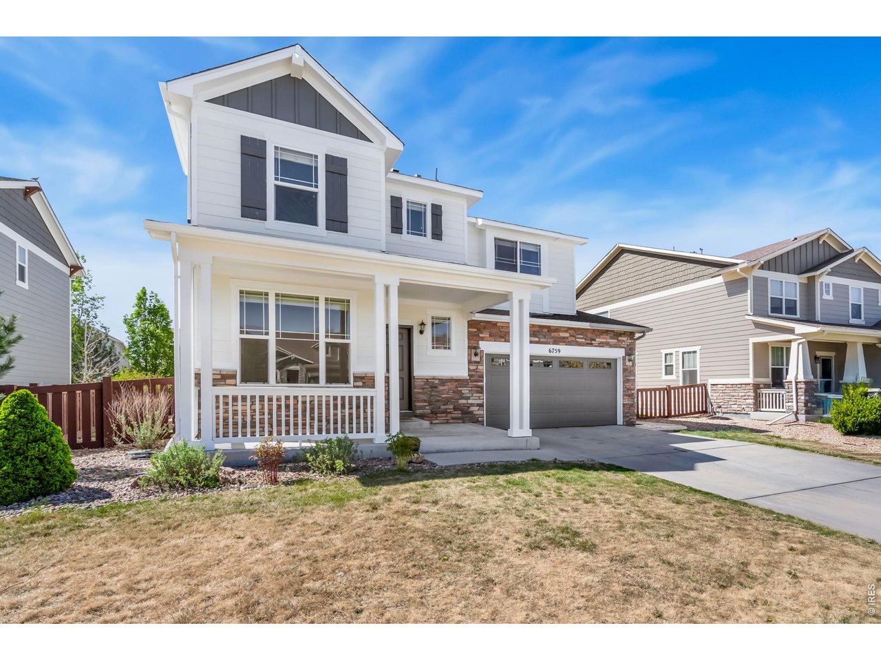 6759 Rainier Road Timnath, CO 80547 - Photo 28 of 30 a front view of a house with garden