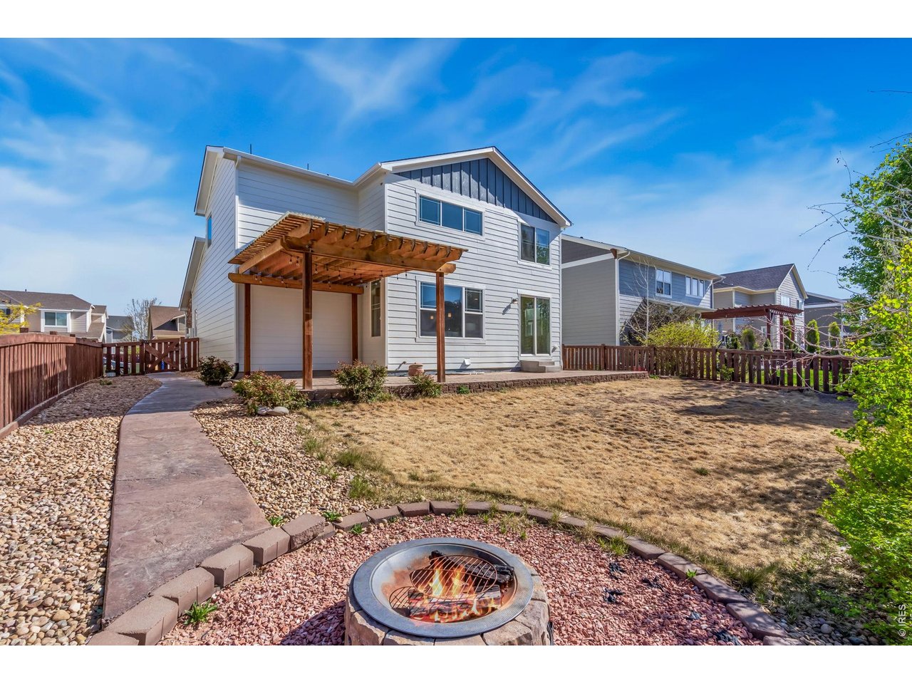6759 Rainier Road Timnath, CO 80547 - Photo 9 of 30 a backyard of a house with barbeque oven table and chairs