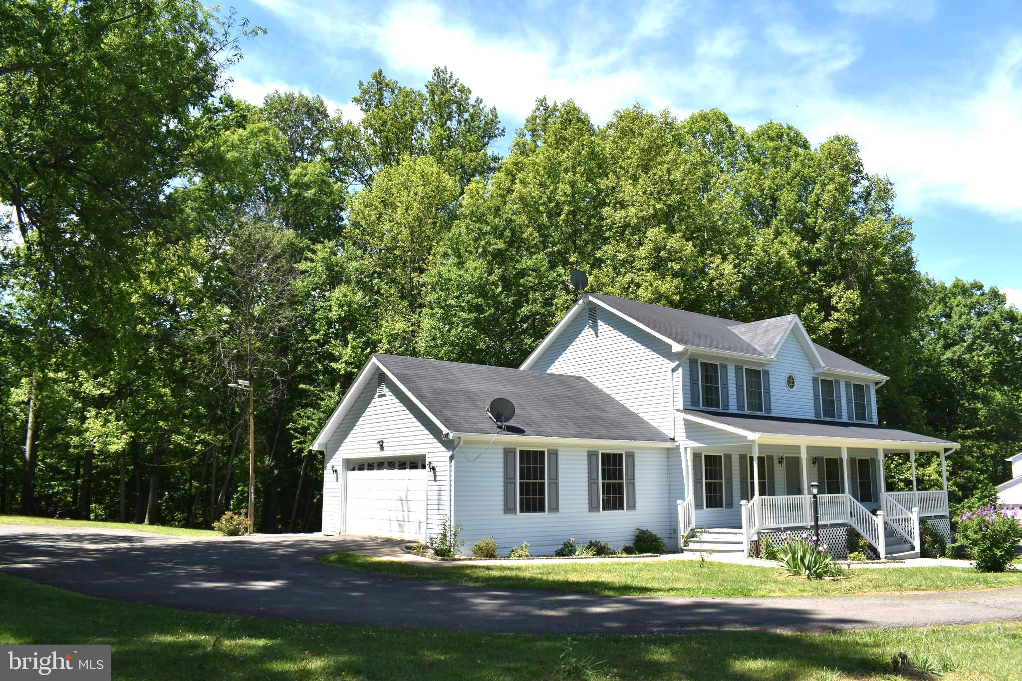10958 Mountain Run Lake Road Culpeper, VA 22701 - Photo 27 of 31 a front view of a house with a garden and lake view