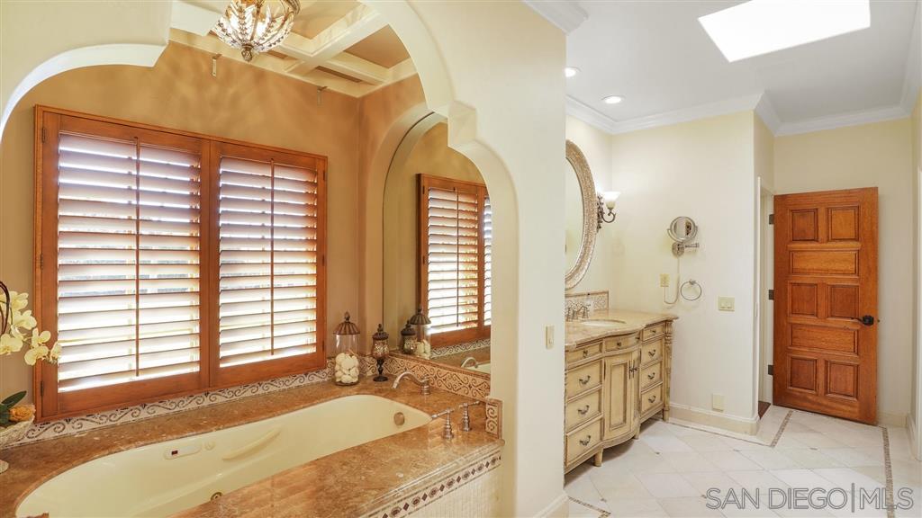 16556 Los Barbos Rancho Santa Fe, CA 92067 - Photo 13 of 22 a spacious bathroom with a granite countertop sink and a bathtub