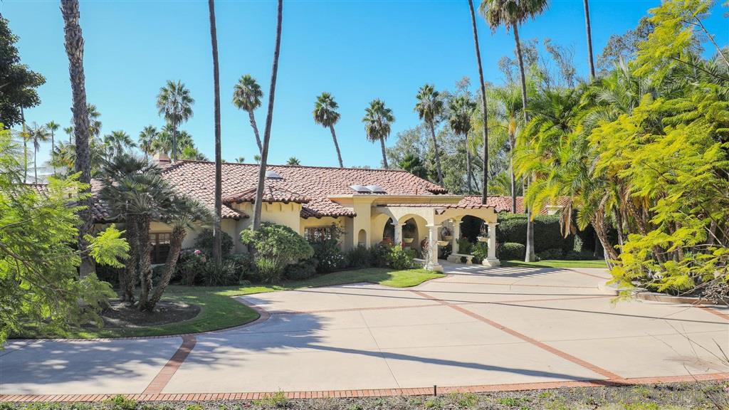 16556 Los Barbos Rancho Santa Fe, CA 92067 - Photo 2 of 22 a view of a white house with a street