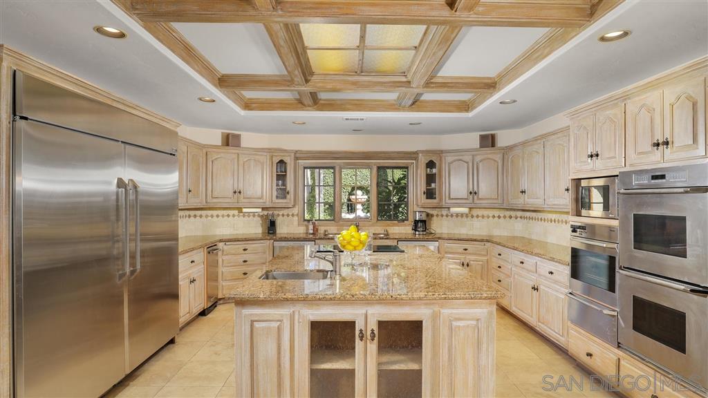 16556 Los Barbos Rancho Santa Fe, CA 92067 - Photo 4 of 22 a kitchen with stainless steel appliances granite countertop a sink a stove and cabinets