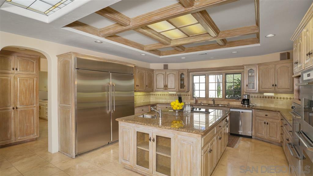 16556 Los Barbos Rancho Santa Fe, CA 92067 - Photo 5 of 22 a kitchen with stainless steel appliances granite countertop a sink stove and refrigerator