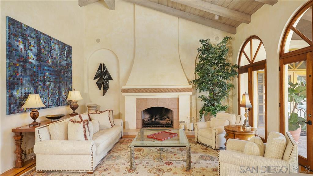 16556 Los Barbos Rancho Santa Fe, CA 92067 - Photo 9 of 22 a living room with furniture and a fireplace