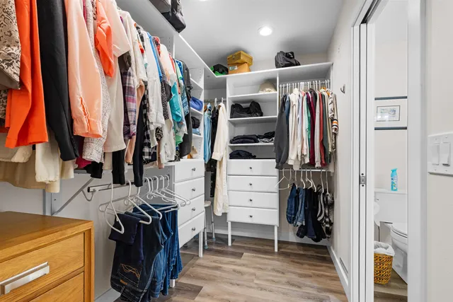 walk in closet with clothes and shoes