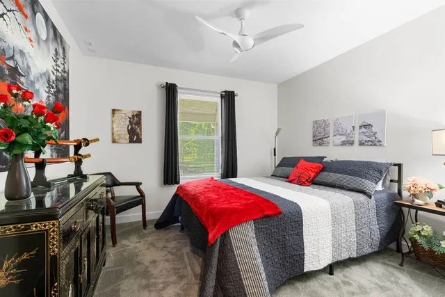 a bedroom with a bed and a desk