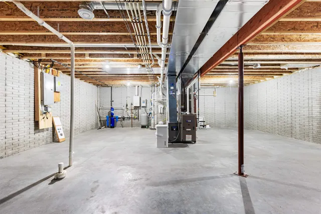 a view of empty room with wooden floor and windows