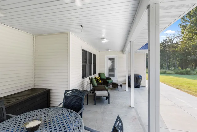 a view of a house with a yard and potted plants