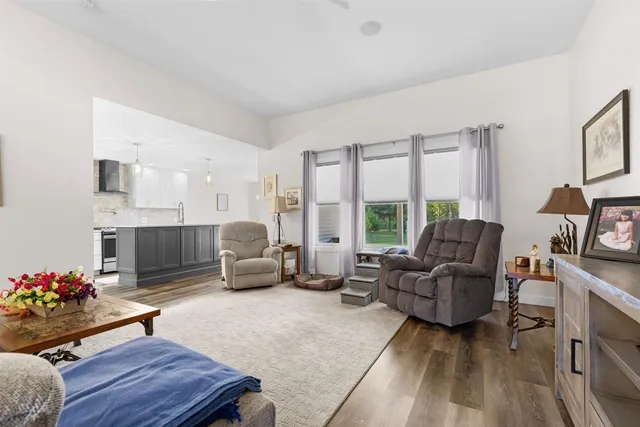 a living room with furniture fireplace and a large window