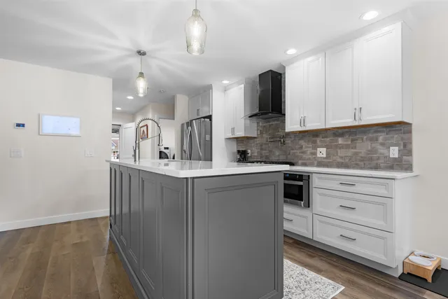 a kitchen with cabinets appliances and a counter space
