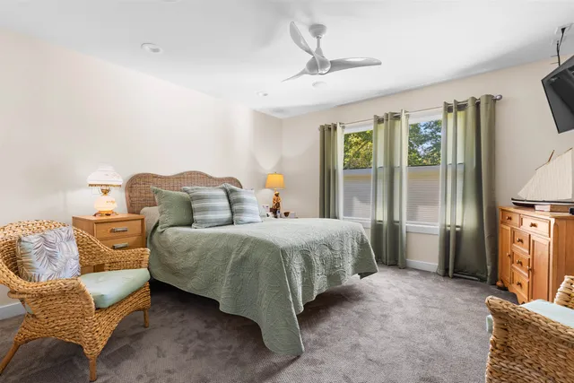 a spacious bedroom with a bed and glass door