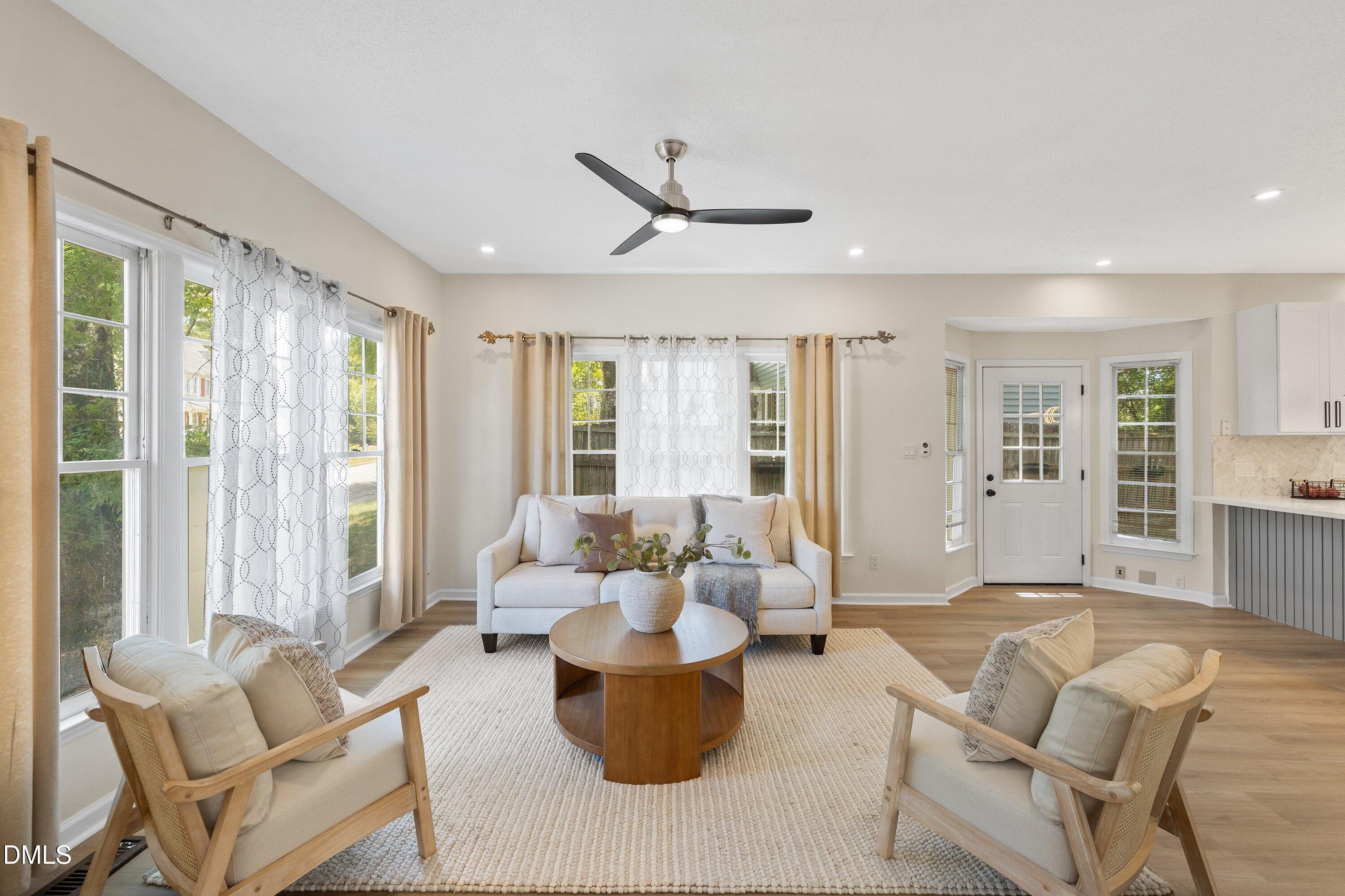 2517 Birchford Court Raleigh, NC 27604 - Photo 16 of 63 a living room with furniture and large windows
