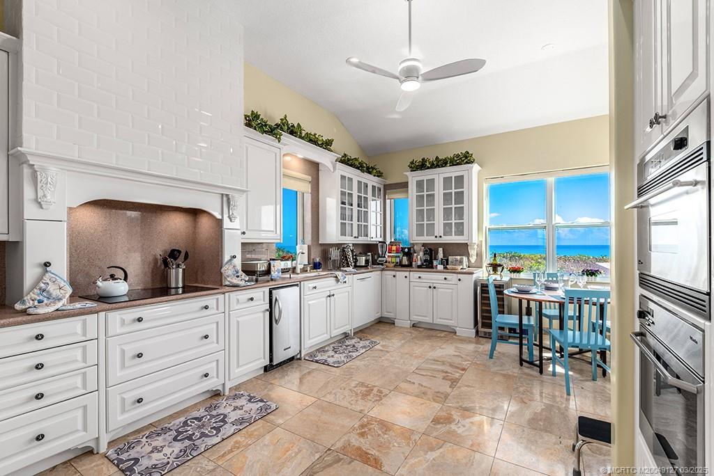 1981 Northeast Ocean Boulevard Stuart, FL 34996 - Photo 16 of 51 a kitchen with a refrigerator and white cabinets