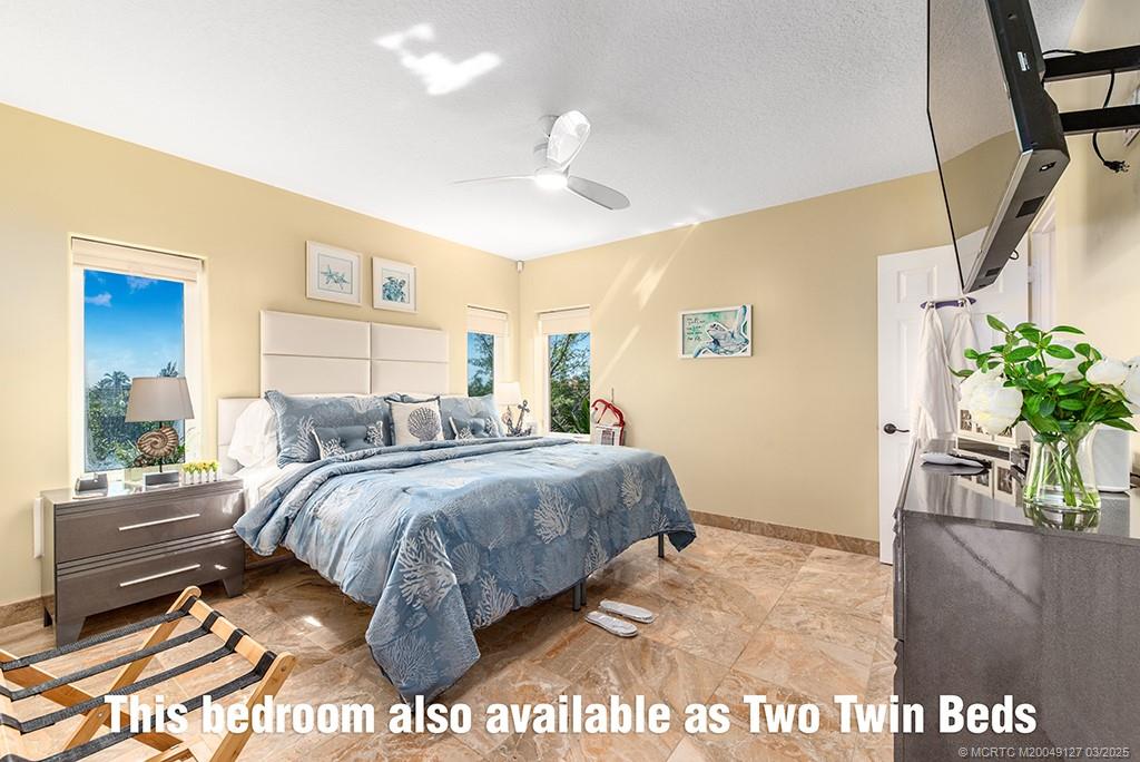 1981 Northeast Ocean Boulevard Stuart, FL 34996 - Photo 25 of 51 a bed room with a bed and a potted plant