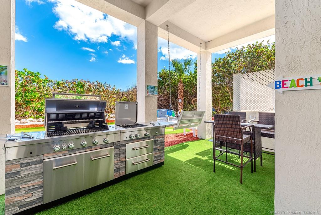 1981 Northeast Ocean Boulevard Stuart, FL 34996 - Photo 26 of 51 a kitchen that has a stove and a chair