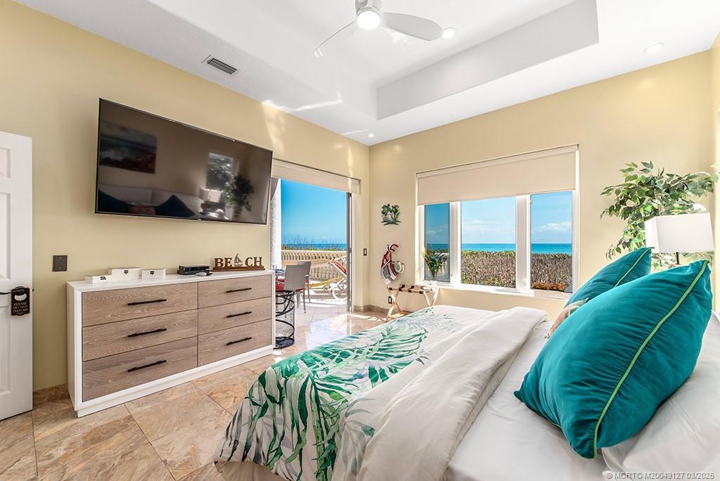 1981 Northeast Ocean Boulevard Stuart, FL 34996 - Photo 30 of 51 a bedroom with a bed and flat screen tv