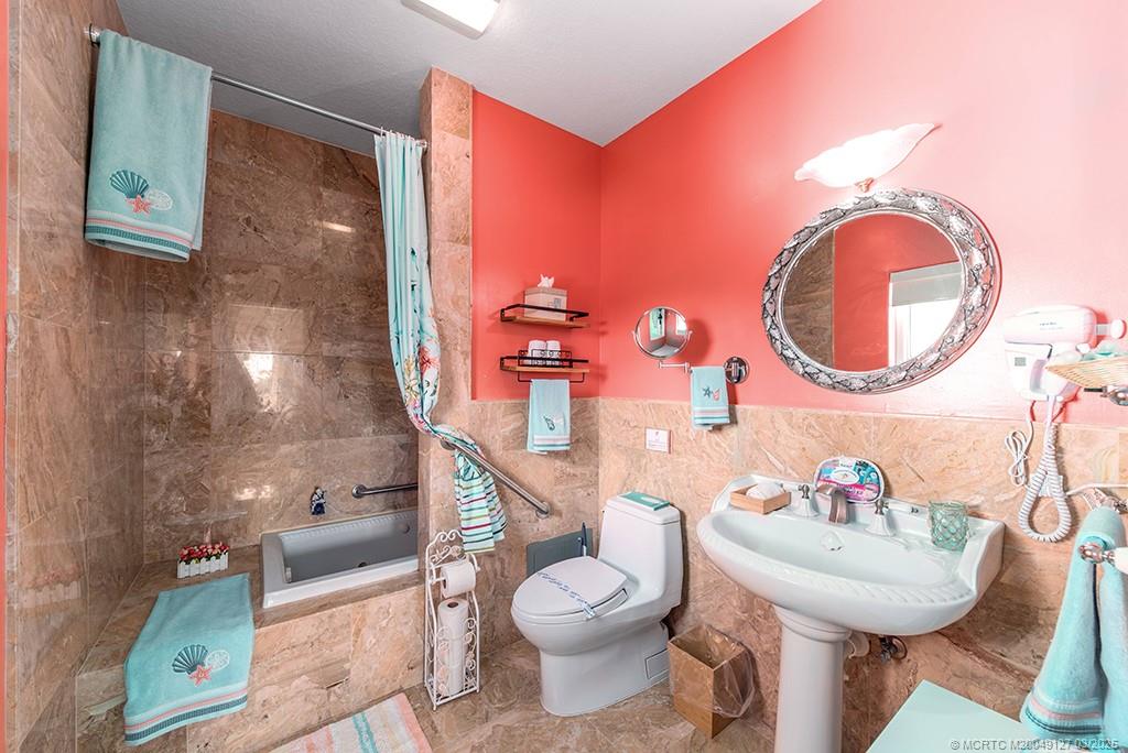 1981 Northeast Ocean Boulevard Stuart, FL 34996 - Photo 31 of 51 a bathroom with a toilet a sink and a mirror