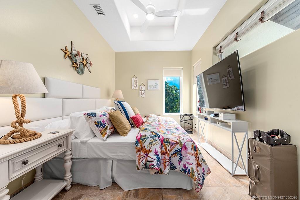 1981 Northeast Ocean Boulevard Stuart, FL 34996 - Photo 33 of 51 a bedroom with furniture and a flat screen tv