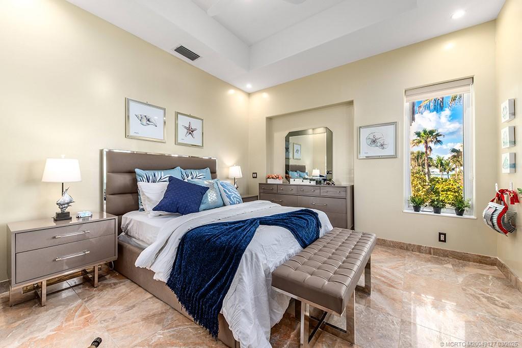 1981 Northeast Ocean Boulevard Stuart, FL 34996 - Photo 34 of 51 a bedroom with a bed and wooden floor