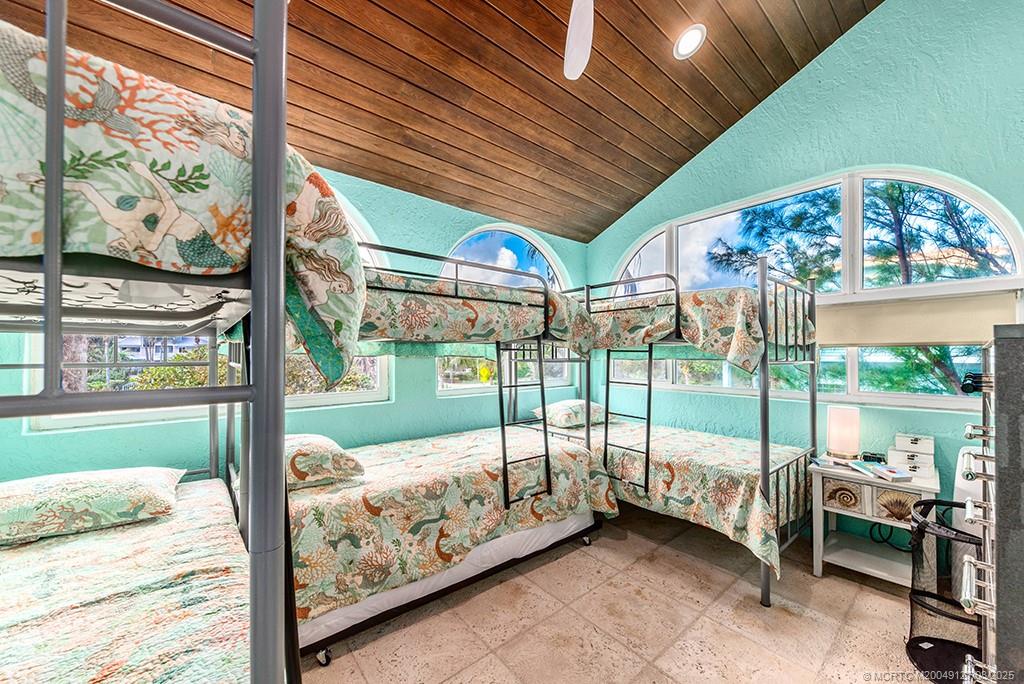 1981 Northeast Ocean Boulevard Stuart, FL 34996 - Photo 35 of 51 a bedroom with furniture with large windows