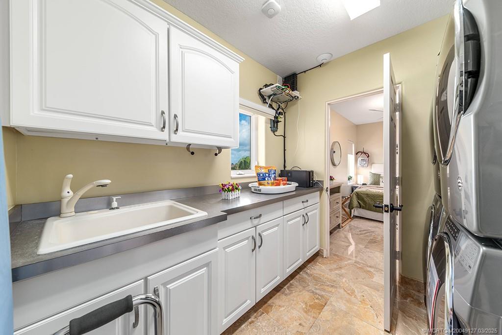 1981 Northeast Ocean Boulevard Stuart, FL 34996 - Photo 37 of 51 a kitchen with a sink appliances and cabinets