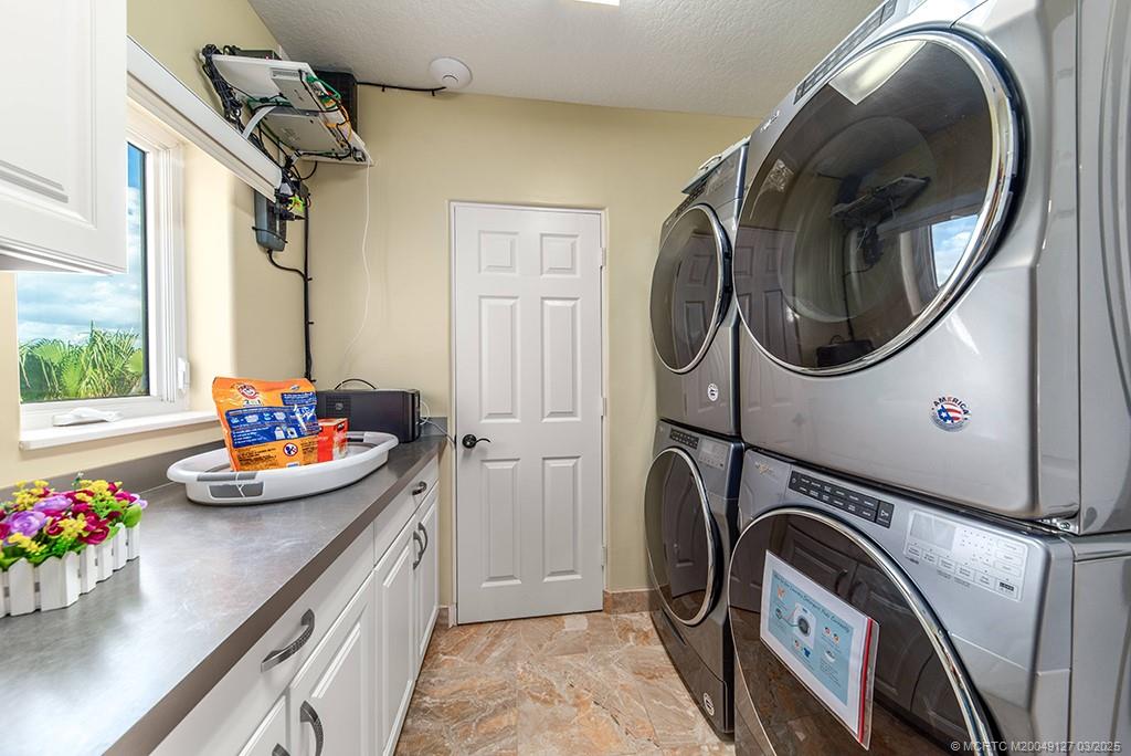 1981 Northeast Ocean Boulevard Stuart, FL 34996 - Photo 38 of 51 a utility room with dryer and washer