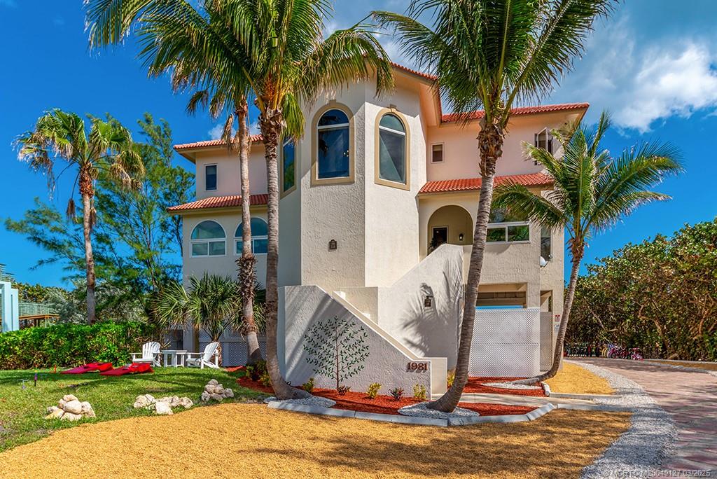 1981 Northeast Ocean Boulevard Stuart, FL 34996 - Photo 5 of 51 a front view of multi story residential apartment building with yard and sign board
