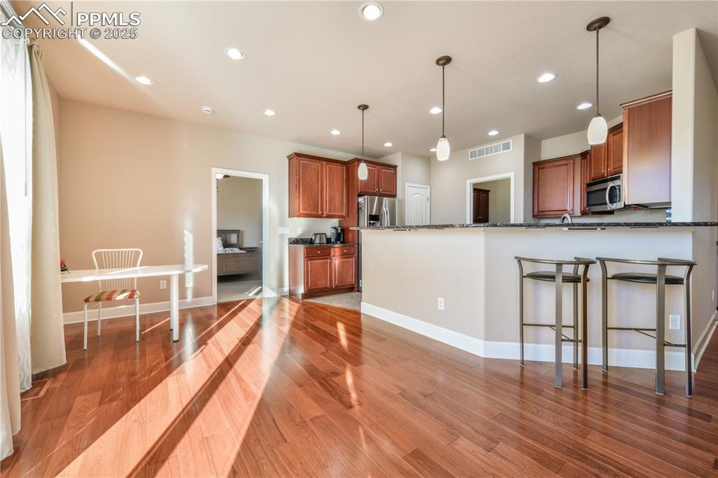 10484 Mile Post Loop Fountain, CO 80817 - Photo 14 of 50 a large kitchen with lots of counter space and a dining table