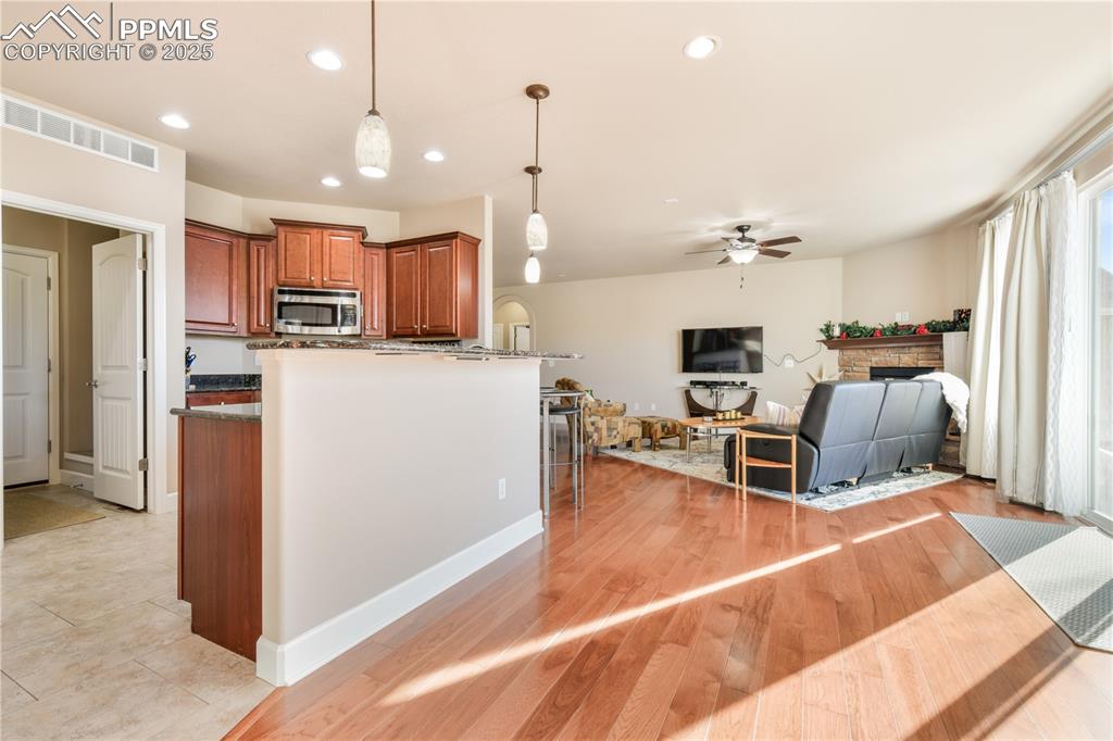 10484 Mile Post Loop Fountain, CO 80817 - Photo 15 of 50 a living room with furniture a kitchen view and a chandelier