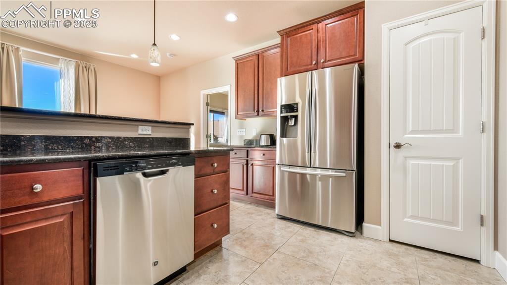 10484 Mile Post Loop Fountain, CO 80817 - Photo 18 of 50 a kitchen with stainless steel appliances granite countertop a refrigerator sink and stove