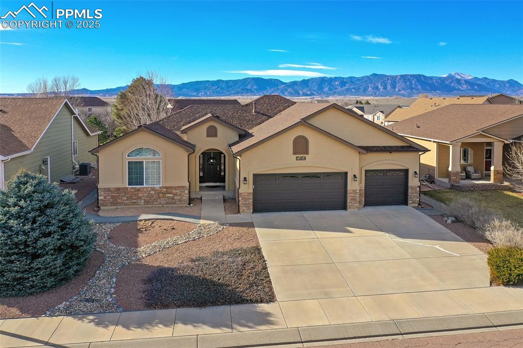 10484 Mile Post Loop Fountain, CO 80817 - Photo 3 of 50 a front view of a house with a yard and garage