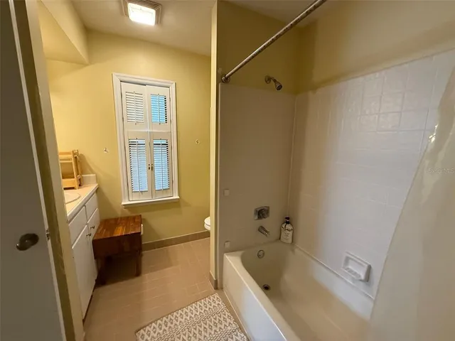 a bathroom with a tub a sink and a shower