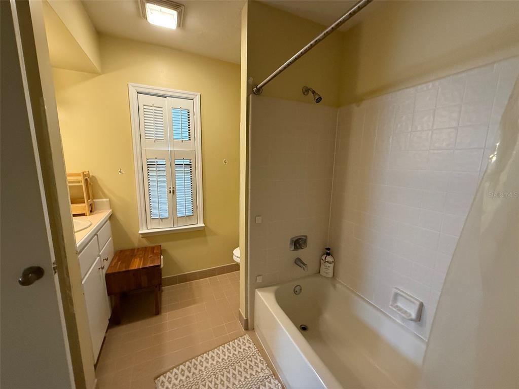 5601 Southwest 83 Drive Gainesville, FL 32608 - Photo 17 of 21 a bathroom with a tub a sink and a shower