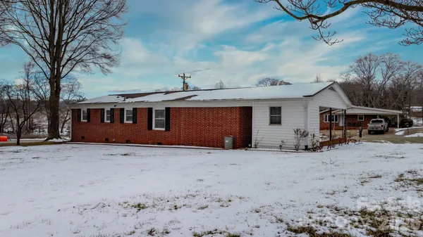 a view of a house with a snow in the yard