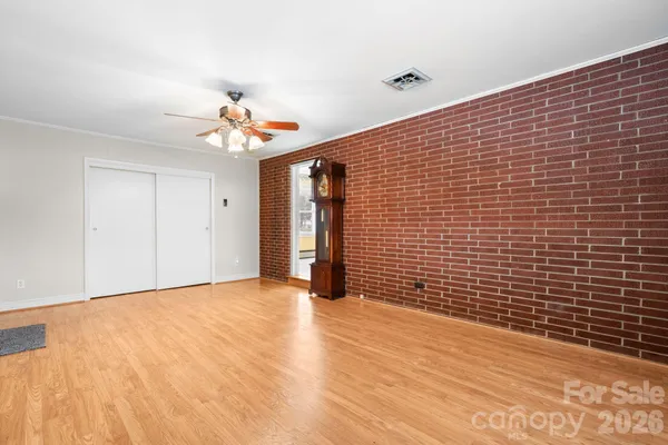 a view of an empty room with wooden floor