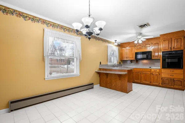 a kitchen with stainless steel appliances granite countertop a stove a sink dishwasher a microwave oven with granite countertops and cabinets